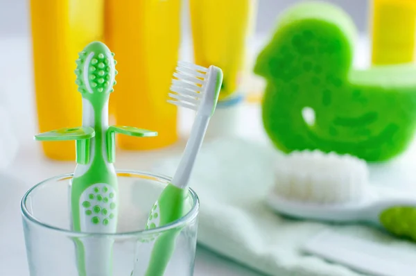 Pair of baby first toothbrushes in the bathroom — Stock Photo, Image