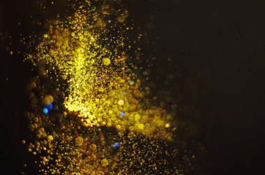 Parlak odaklı sahte altın parçacıklarına sahip soyut arkaplan