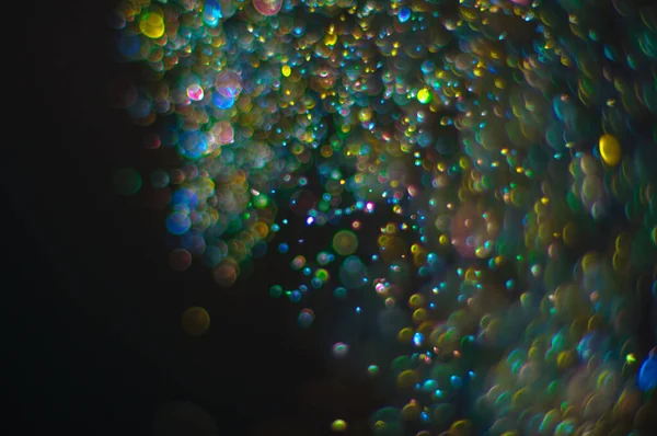 輝く集束ボケ多色粒子を持つ抽象的背景 — ストック写真