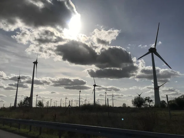 Wind farm with blue sky and sunshine and clouds