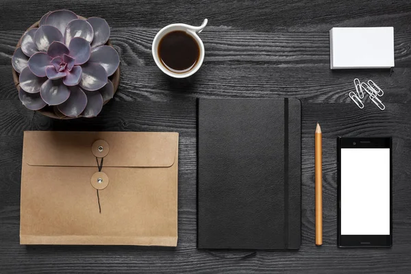 Black desk with office items