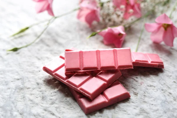 Pink chocolate.A plate of pink chocolate.