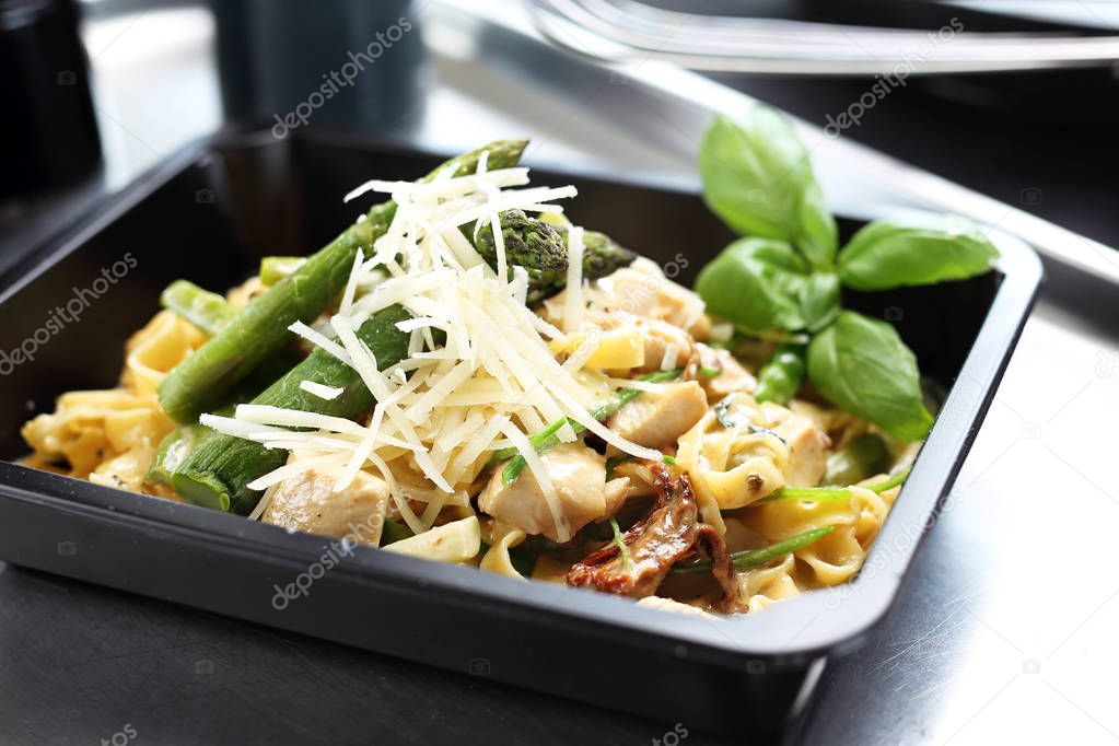 Pasta with asparagus. Take-out dish. Lunch box. 