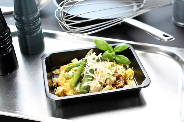 Lunch box. Pasta with asparagus. Take-out dish