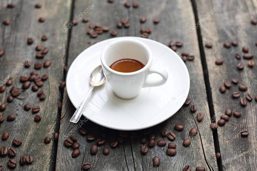 Espresso, cup of coffee on a wooden background.