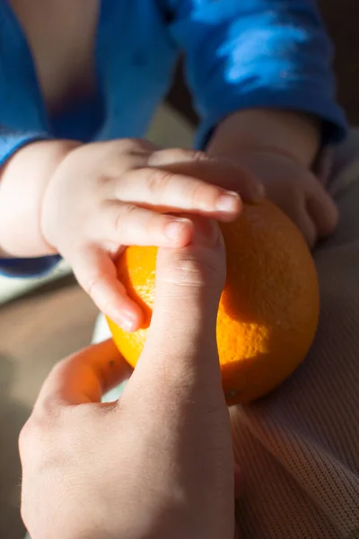 A child plays with a pumpkin on the sill Stock Image