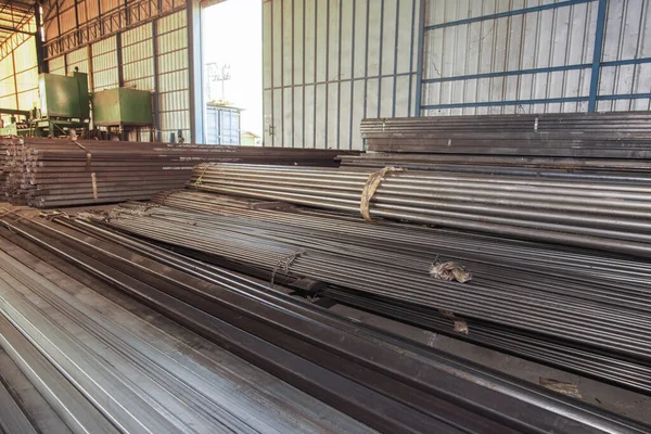 Steel rods IN shape.Stock warehouse many kind of iron tube, carbon steel,pipes round iron.Stock types of steel are new to work construction and building systems.