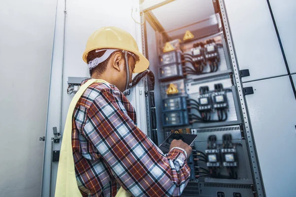 Control cabinet ,Control Room Engineer. Power Plant Control Panel. Engineer standing in front of the control panel in the control room.