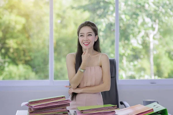A beautiful young woman with job,happy young woman working a lot document,Happy women working in the office with nature.