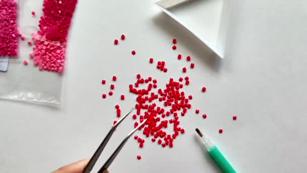 Red Diamond Mosaic Scattered White Background Girl Takes Mosaic Tweezers — Stock Video