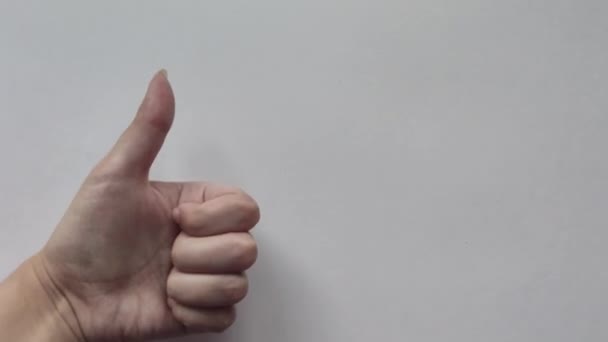 White Girl Shows Left Handed Sign White Background — Stock Video