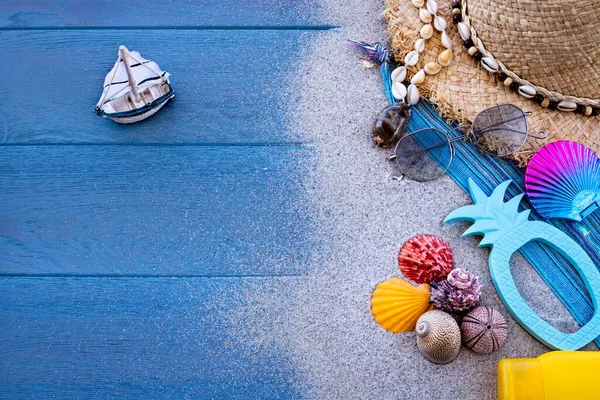 Beach sand and accessories with a sailing boat. Seaside concept with seashells