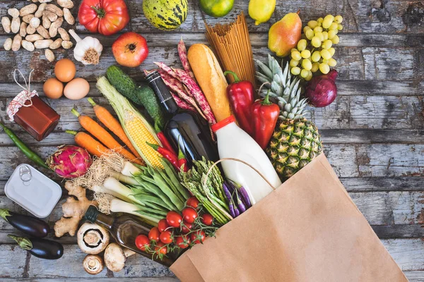 Fresh vegetables in the paper bag. Shopping concept with top view.