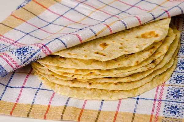 Food. Bakery products. Pita or Indian chapati on textile background.