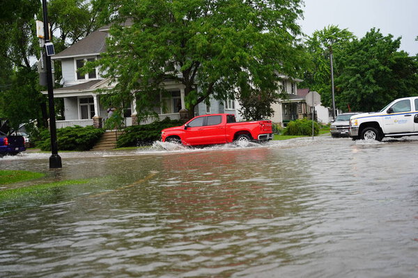 Citizens of Fond du Lac drive through the flooded streets in their vehicles from the huge downpour of rain during the afternoon in july 2020.  