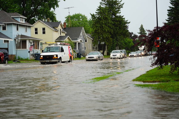 Citizens of Fond du Lac drive through the flooded streets in their vehicles from the huge downpour of rain during the afternoon in july 2020.  