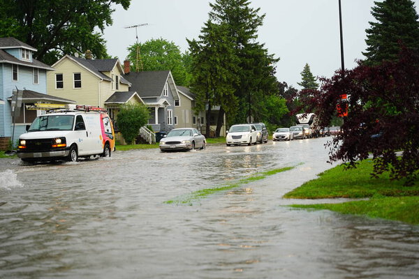 Citizens of Fond du Lac drive through the flooded streets in their vehicles from the huge downpour of rain during the afternoon in july 2020.  