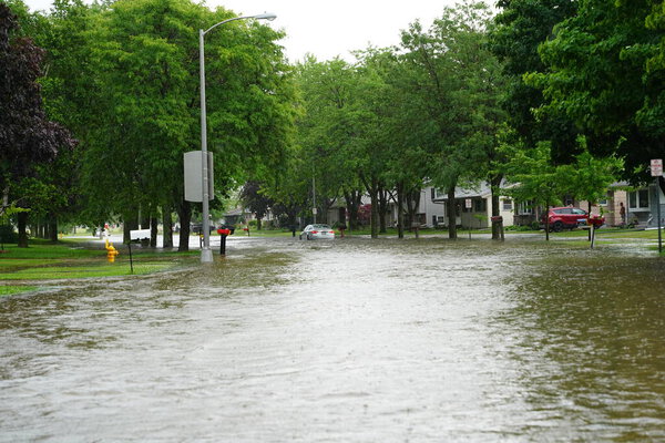 Citizens of Fond du Lac drive through the flooded streets in their vehicles from the huge downpour of rain during the afternoon in july 2020.  