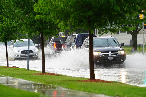 Citizens of Fond du Lac drive through the flooded streets in their vehicles from the huge downpour of rain during the afternoon in july 2020.  