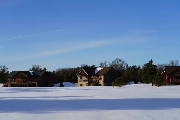 New Lisbon, Wisconsin USA - February 25th, 2023: Wooden cabin houses in the Winter season.