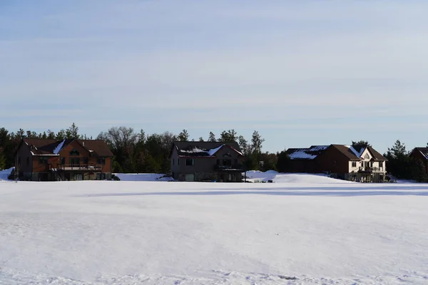 New Lisbon, Wisconsin USA - February 25th, 2023: Wooden cabin houses in the Winter season.