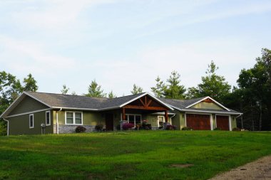 İki yeşil bitkisi olan modern bir evin güzel bir fotoğrafı.