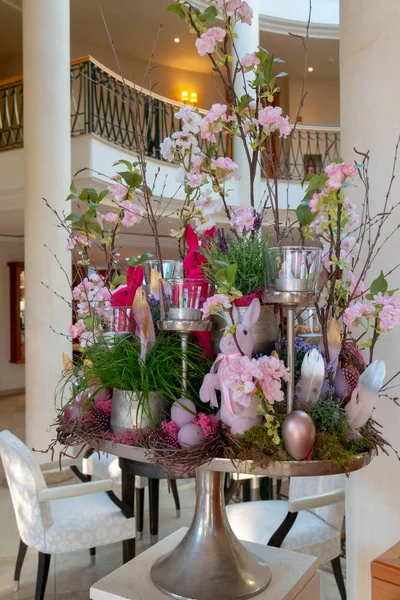 an artfully arranged Easter arrangement stands in the foyer of a