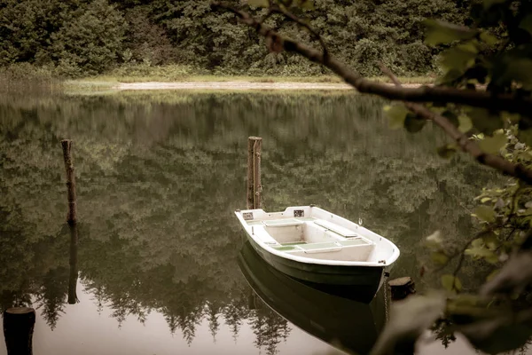 Un bote de remos encadenado flota en un lago — Foto de Stock