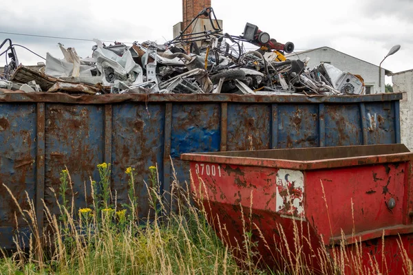 Metal scrap is located in large containers