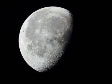 a very dense close-up of a decreasing moon in the night sky clipart
