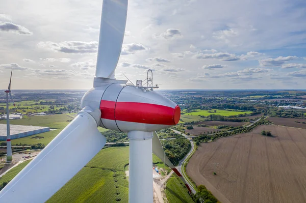 A large wind farm with many wind turbines is built near a small