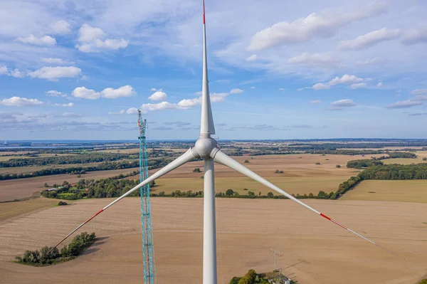 A large wind farm with many wind turbines is built near a small