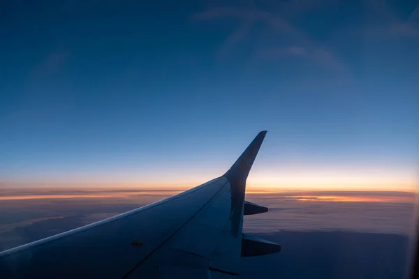 A asa direita do avião sobe para o céu azul — Fotografia de Stock