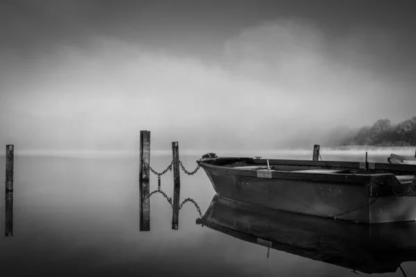 On a lake some rowboats are moored and on the lake there is fog — Stock Photo, Image