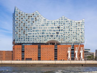 the Elbphilharmonie in Hamburg in fine weather and the sky is blue clipart