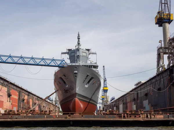 Stock image A frigate is being repaired in a dry dock at Blohm und Voss in Hamburg