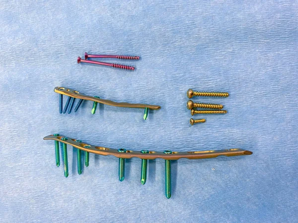 Explanted Titanium Screws Titanium Plates Different Colors Sizes Lie Blue — Stock Photo, Image