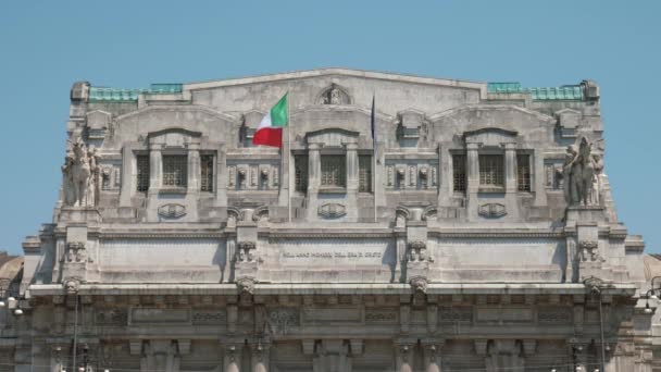 Bandeiras italianas e europeias agitam-se ao vento na Estação Central de Milão — Vídeo de Stock