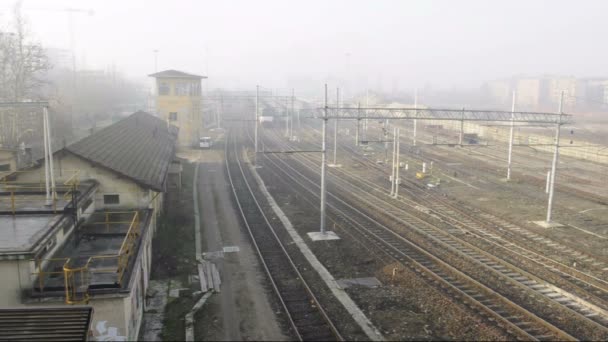 Wide shot of train passing by, filmed from above in Pavia Station, PV, Italy — Stock Video