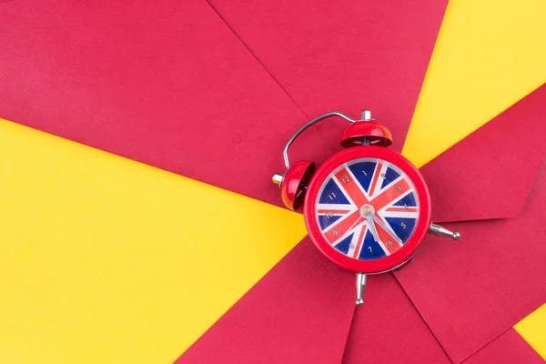 English clock with the colors of the British flag. Time to learn English.