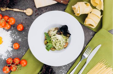 Yeşillik, oklava, makarna ile süslenmiş zeytin rengi ile spagetti.