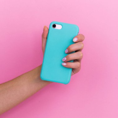Pembe arka planda nane kılıfı içinde akıllı telefon.