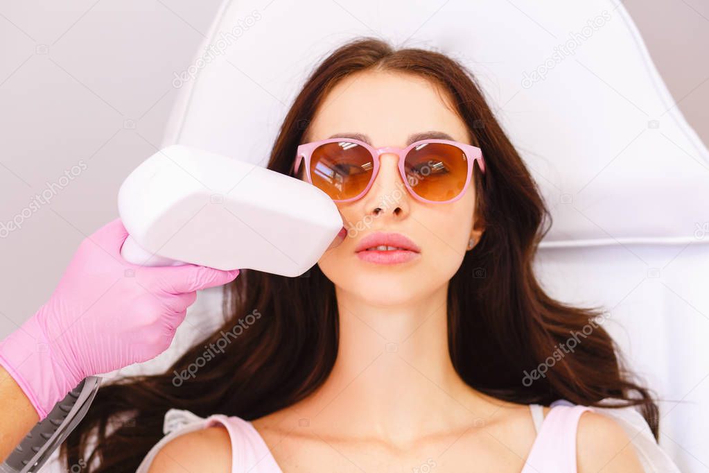 Laser hair removal in professional beauty studio. 