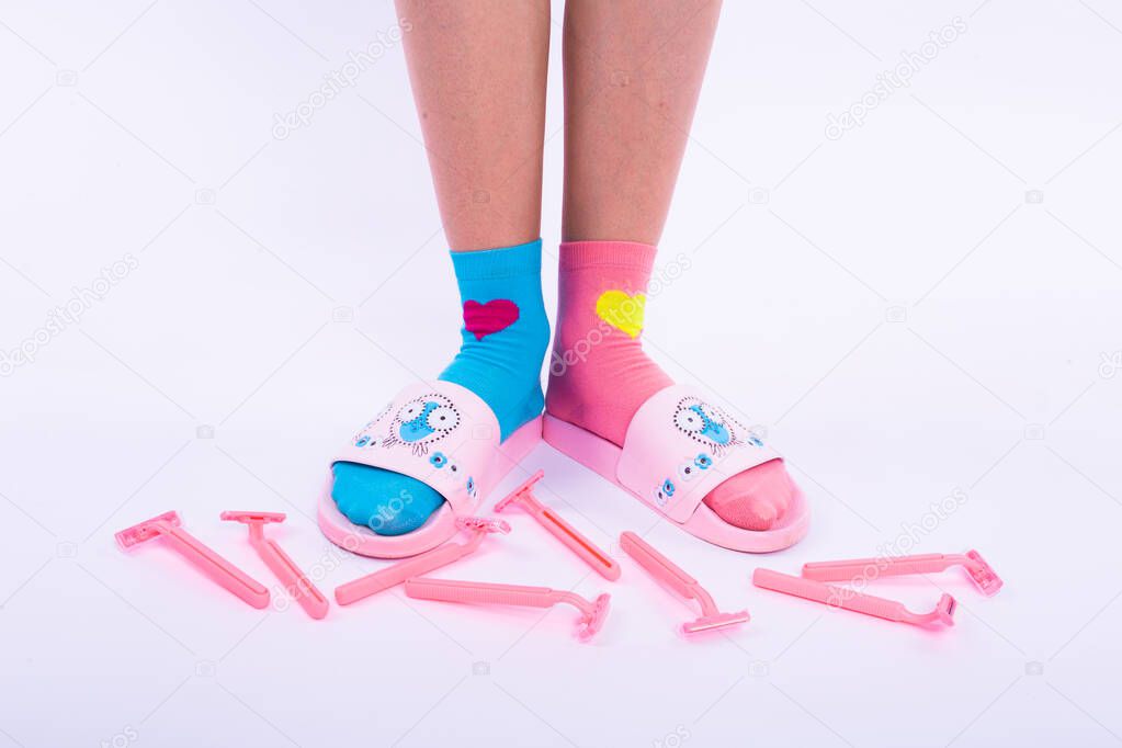 Female smooth legs in colored socks. Epilation.