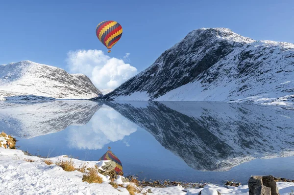 view of air balloon over mountain lake at winter season