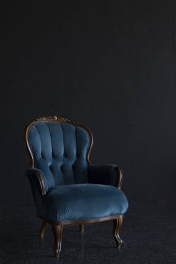 siyah bir duvara karşı mavi sandalye