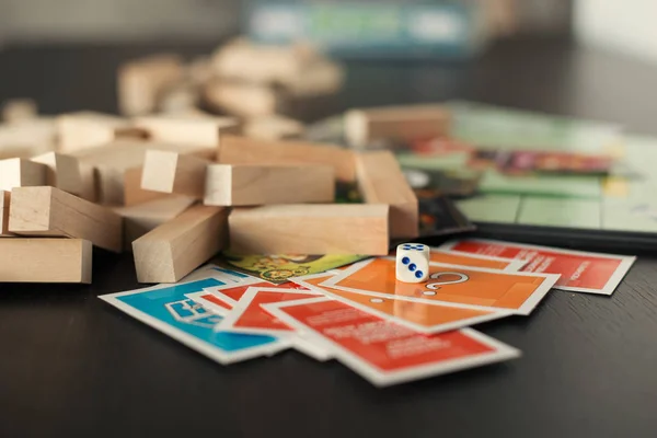 Colorful play figures and cards with dice on board — Stock Photo, Image