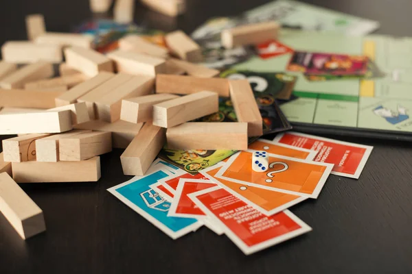 Colorful play figures and cards with dice on board — Stock Photo, Image