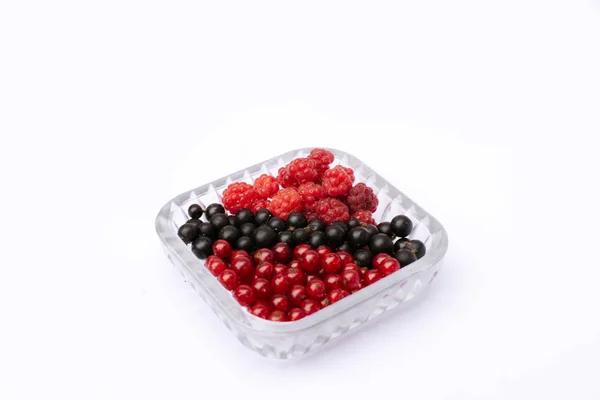 Set of fresh berries of currant and raspberry in a plate on a white background. isolated berries — Stock Photo, Image