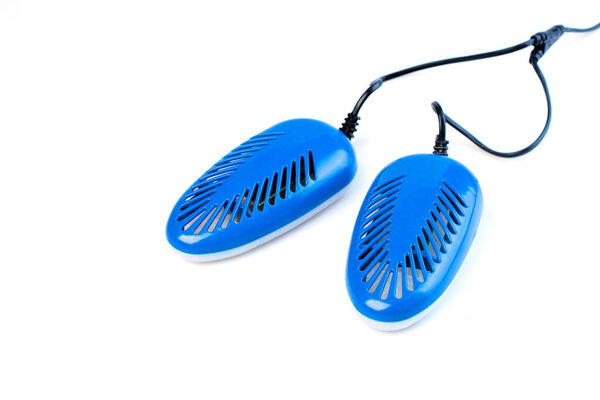 blue electric shoe dryer isolated on a white background. shoe protection and hygiene in the autumn-winter period